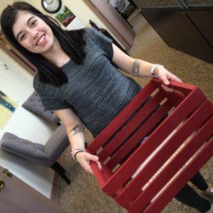 Kelsey poses with one of our new Discovery Bins. Come visit to find out what's inside!
