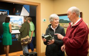 Visitors at a "hands-on" display during the opening reception. Photography by Lori Johnson.