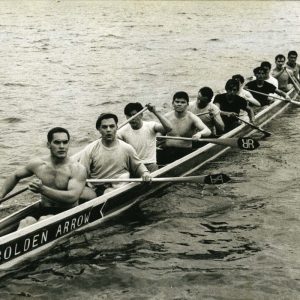 Photograph shows a group portrait of the Golden Arrow racing canoe and crew on Cultus Lake in the spring of 1968. Crew members were from the Skwah First Nation. From left to right: Jack Mussell, Bill Mussel Jr., Joe Mussel, Lester Mussell, Jack Fraser, Percy Wallace, Jim Fraser, Melvin Mussell, Roy Mussell, Dick Mussell, and Fred Mussell. [1981.066.002]