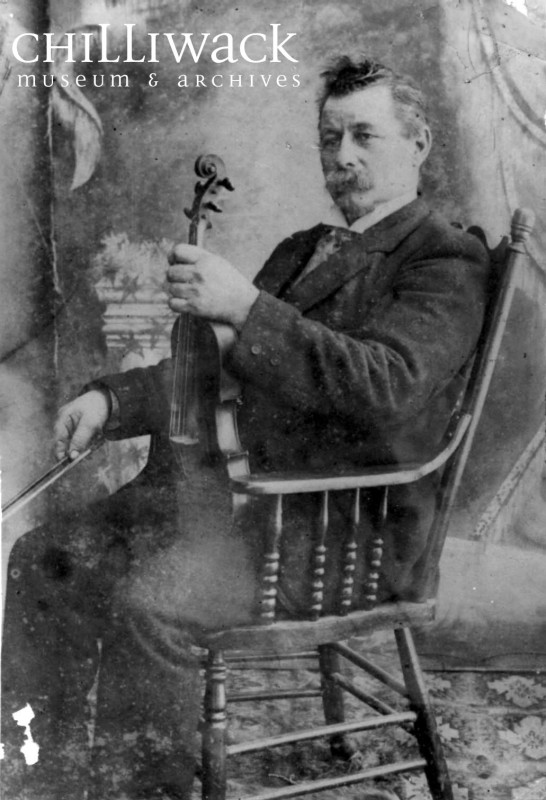 Image of George Chadsey siting with his violin.  