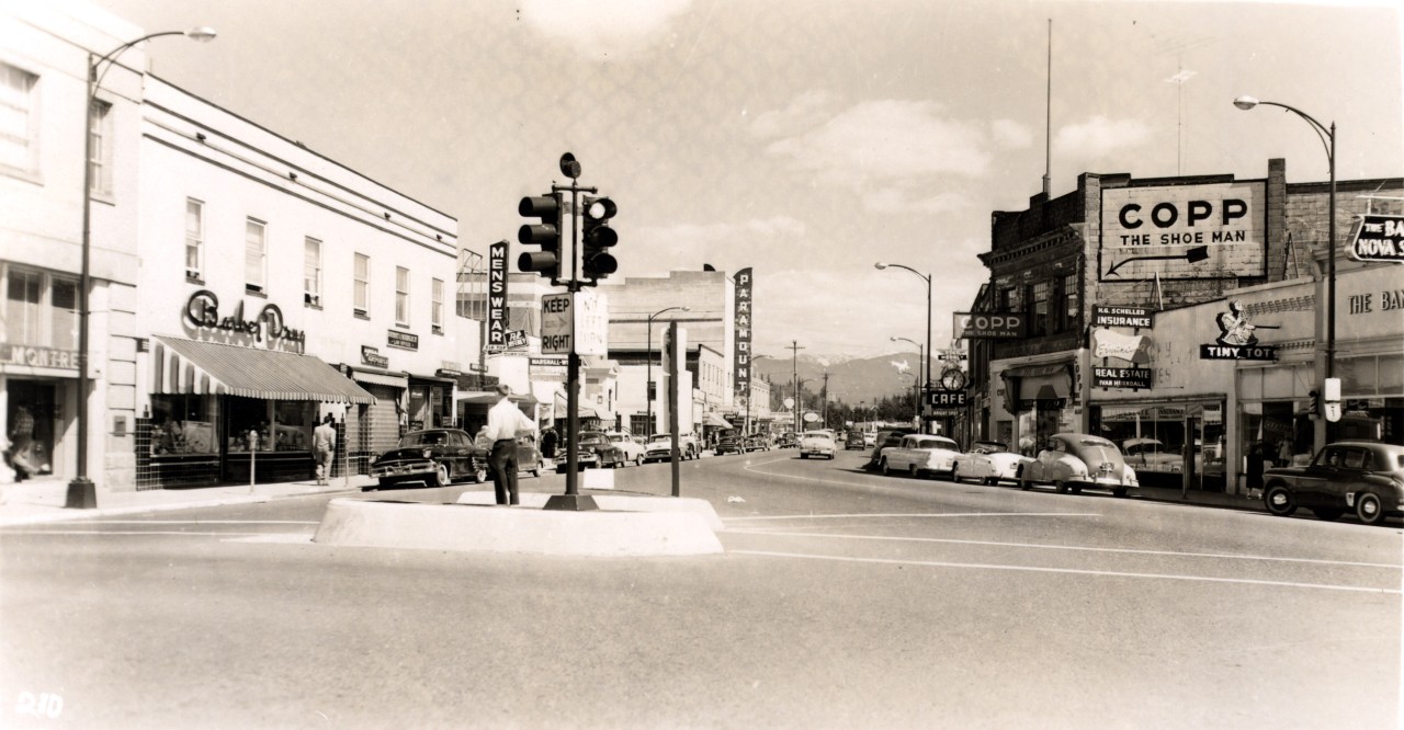 Photographer: J.C. Walker. 
Photograph consists of a street level view of commercial buildings and businesses on Yale Road East, as seen from Five Corners, ca. 1958.  [1981.021.040] 